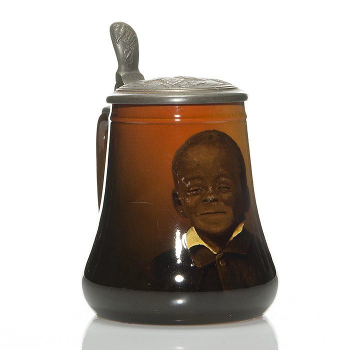 Rookwood stein, black portrait, Horsfall, ‘95, 6 1/2”: Rookwood Standard glaze stein with pewter lid and portrait of an African American boy done in 1895 by Bruce Horsfall. The lid with built in thumb latch is one used on several comparable steins but rar