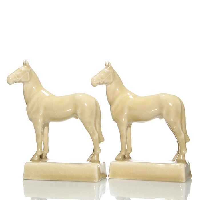 Pr Rookwood Man-o-War bookends, tan, 6 1/2”: Pair of Man-O-War bookends, cast in 1946 and covered with a tan high glaze. Marks include the Rookwood logo, date, shape 6202 and “39” incised on each. There is overall crazing which is common for