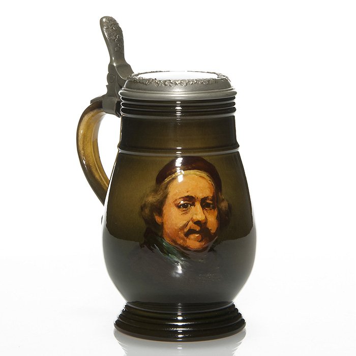 Rookwood Standard stein, Rembrandt, Daly, ‘95, 8”: Good Rookwood Standard glaze lidded stein with a self portrait after Rembrandt done in 1895 by Matt Daly. A pewter support with thumb latch encases the lid and attaches it to the handle of the mug. Ma