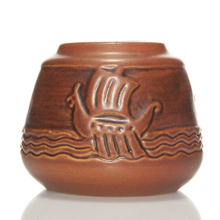 UND Viking Ship vase, Mattson, 2 7/8”: UND vase with three Viking ships, a Julia Mattson design. Marked with the circular UND logo and incised “Viking Ship # 56” along with Mattson’s incised signature. Height 2 7/8 inches. Excellent 