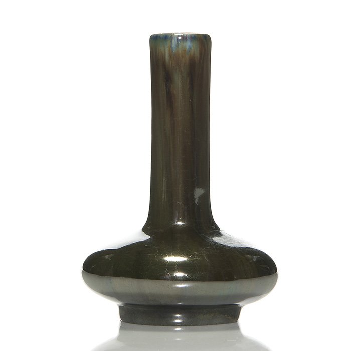 Fulper bottle vase, Mirrored Black glaze, 5 1/4”: Fulper Pottery bottle vase covered in a nice example of the Mirror Black glaze with blue and brown highlights at the rim. Marked on the bottom with the Fulper “racetrack” ink stamp. There are a fe