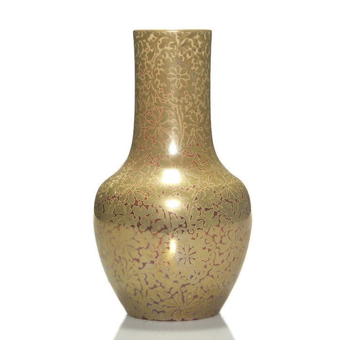 Clement Massier metallic glaze vase, 1888, 9 3/4”: Clement Massier reflective metal glaze vase with floral design done in 1888. Gold flowers completely cover the surface of the vase with hints of maroon background in the lower half. Signed “C.M. 188
