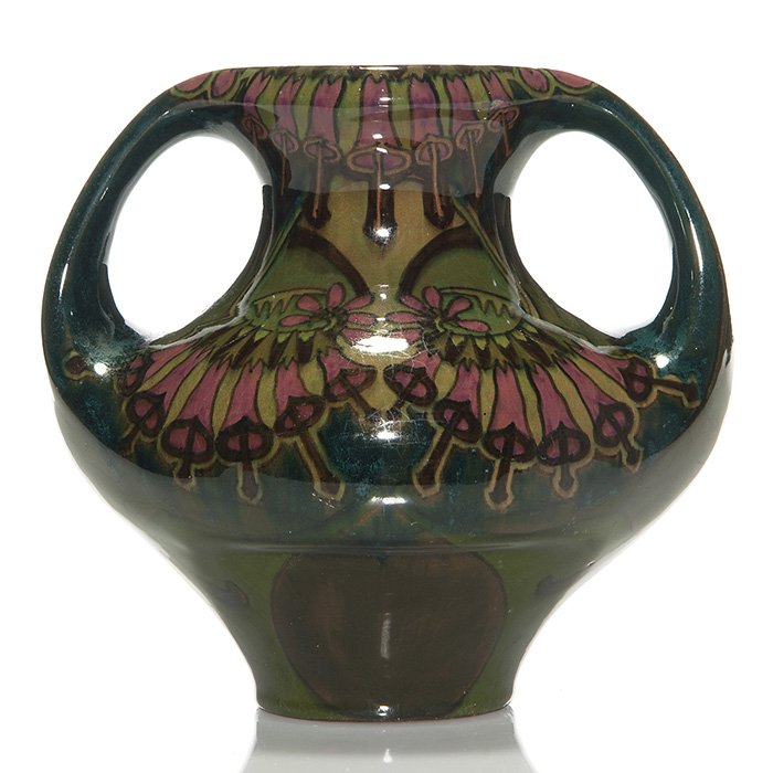 Distel high glaze vase, artist signed, 6 1/2”: Distel Pottery twin handled vase decorated with a high glaze floral design. Marked on the bottom in black slip “Distel M:199 D 1, 31/7 99” and the artist’s initials “GM” in script. There is 