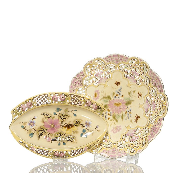 2 Zsolnay items: plate and oval dish, 11 1/2”: Two early Zsolnay items: 1. Oval serving plate with floral decoration and reticulated rim. Impressed “Zsolnay Pecs 3421” on the underside. Measures 7 1/8 by 10 1/2 inches. Two lines in the complex