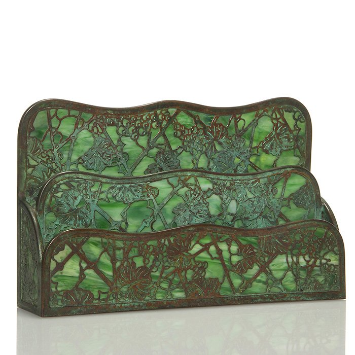 Tiffany Grape Leaf bronze letter holder, 6 1/4”X10”: Bronze Tiffany “Grape Leaf” two section letter holder backed by green slag glass. Measures 6 1/4 inches tall by 10 inches by 2 1/2 inches deep. Impressed “Tiffany Studios, New York” below. Cra