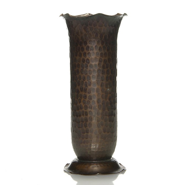 Roycroft hammered copper vase, 10”, marked: Roycroft copper vase with a neat hammered design and scalloping at the rim. Below the cupped foot is the Roycroft impression with the orb insignia. Measures 10 inches by 4 1/2 inches across the rim. G