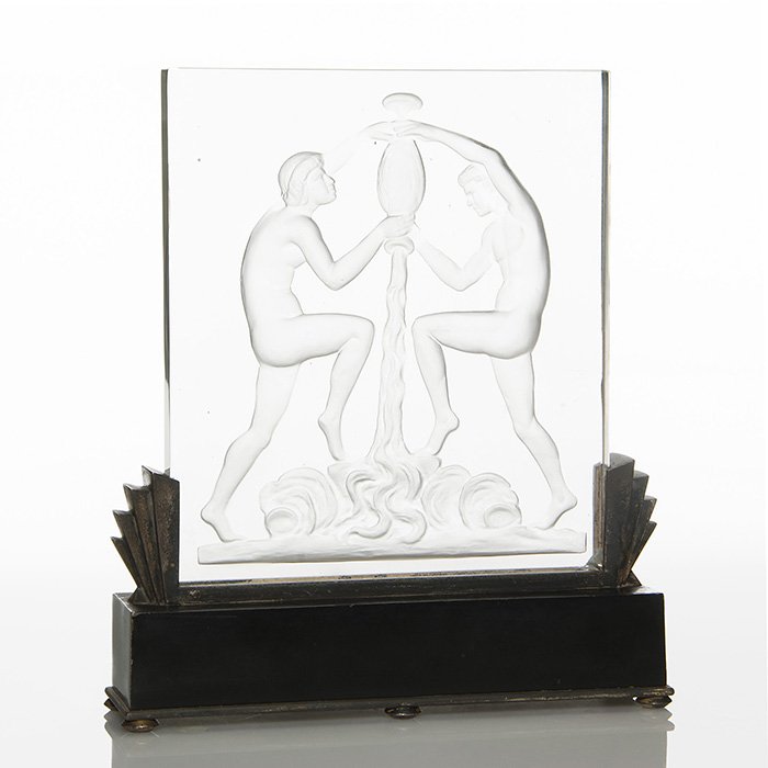 Steuben Luminor and stand, shape 8461: Good Steuben Art Deco luminary, shape 8461. The crystal glass is intaglio carved with a nude woman and a nude man clutching an inverted vase expelling a generous gush of water descending and churning