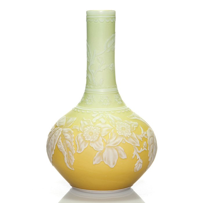 English cameo vase, green to yellow, floral, 7”: Good English cameo stick vase, attributed to Stevens & Williams exhibiting a beautiful bicolor blend of willow green and golden ochre. Encircling the body is a well detailed apple blossom branch compl