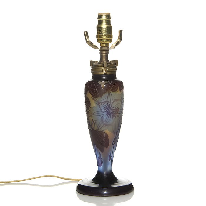 Galle’ cameo lamp base, clematis, 7 1/2”: Miniature Galle’ cameo boudoir lamp displaying a blue clematis framed by brown leaves over beige and blue. Galle’ cameo signature on the side. Glass height 7 1/2 inches. Replaced light socket and 