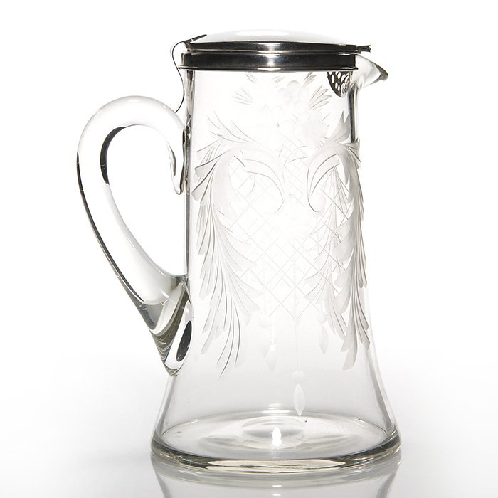 Hawkes tankard, sterling lid, both marked, 9 1/4”: Hawkes crystal lemonade tankard displaying a wheel carved design and fitted with a unique sterling front hinged cover, a strainer at the spout. Height 9 1/4 inches. The Hawks acid trademark is beneath