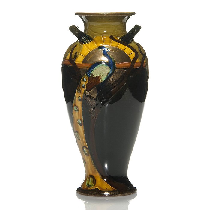 Forester Phoenix Ware vase, peacock, 12 3/4”: English Phoenix Ware vase by Thomas Forester & Sons depicting a peacock perched high up a tree before a golden sun, his tail trailing the the trunk. Height 12 3/4 inches. Traces of a gold circular fac