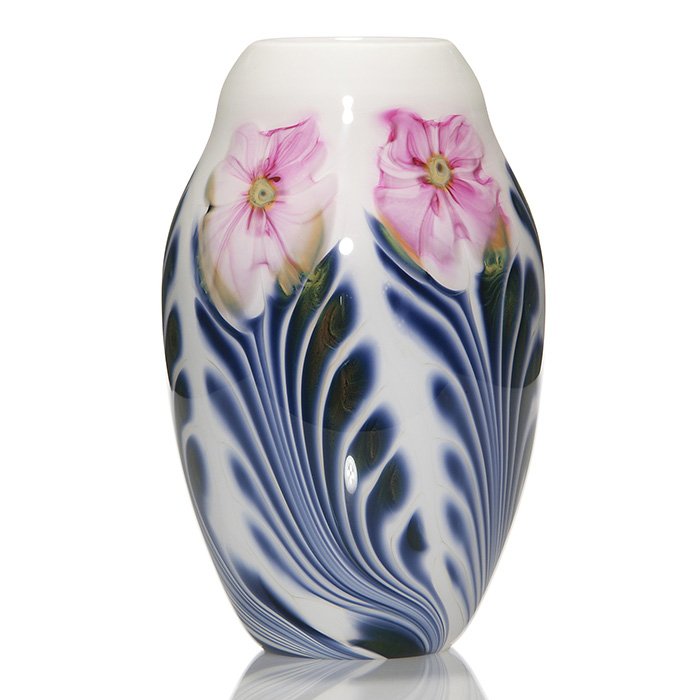 C. Lotton Multi Flora vase, 9 3/4”, 1987, signed: Early Charles Lotton Multi Flora vase with a bridal white body displaying pink flowers above cobalt and and green foliage. Height 9 3/4 inches. Engraved “Charles Lotton Multi Flora, 1987” on the s