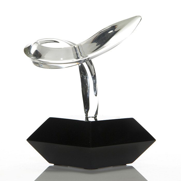 Cartier, Guyol glass sculpture, black base, 6 1/2”: Glass sculpture by Canadian artist Guyol for Cartier resembling a graceful curling crystal leaf blade situated within a facet polished ebony base. Combined height 6 1/2 inches. The base is marked Guyo