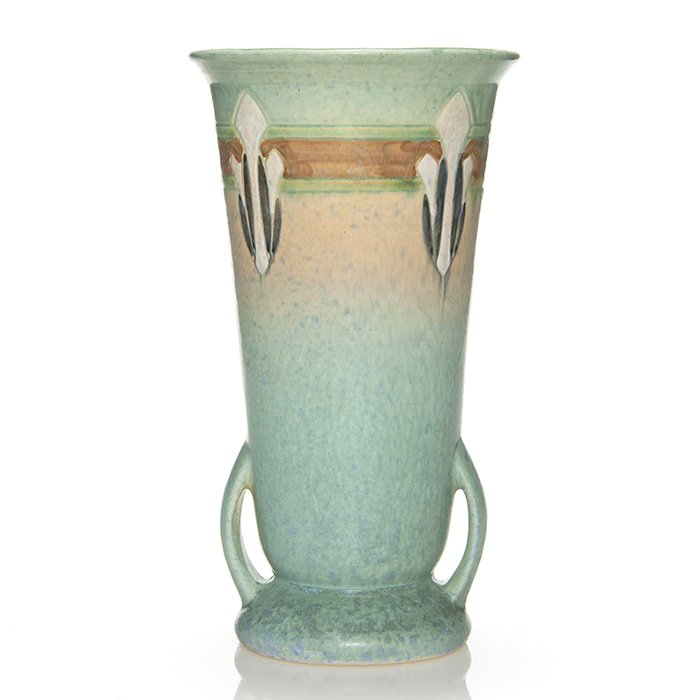 Roseville Montacello vase, 10 1/2", shape 565-10": Roseville Montacello vase, shape 565-10" with a turquoise blue glaze. Height 10 1/2 inches. Teensy nick on base. Glaze runs to interior. Nice mold and glaze. In otherwise excellent condition.