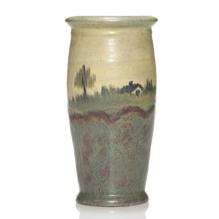Peters and Reed Landsun landscape, house, 8": Peters and Reed Landsun cylinder vase with a house and fence in the distance and foliaged shrubs painted on the lower section of the body. Height 8 inches. Faint crazing. Tiny glaze nicks on the base.