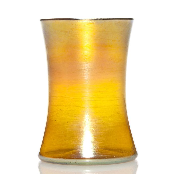 Tiffany iridescent gold tumbler, 4 1/4", signed: Tiffany corset form tumbler in iridescent gold. Height 4 1/4 inches. Engraved "L.C.Tiffany-Favrile, 1176E" beneath. Button pontil. The interior casts a pretty amethyst reflection. Excellent condition.