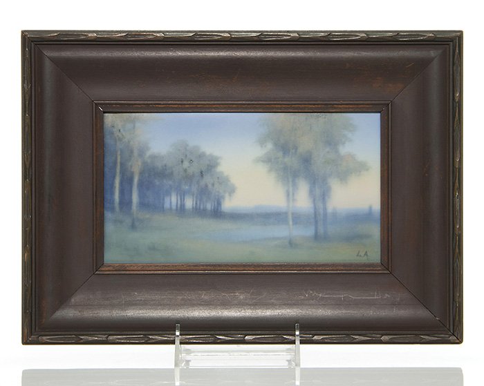 Rookwood Vellum plaque, Asbury, '29, 4 3/4x8 5/8": Vellum glaze plaque titled A Misty Morning, painted by Lenore Asbury in 1929, showing trees around a small lake and having a hazy or misty quality to the decoration. Marked on the back with the Rookwo