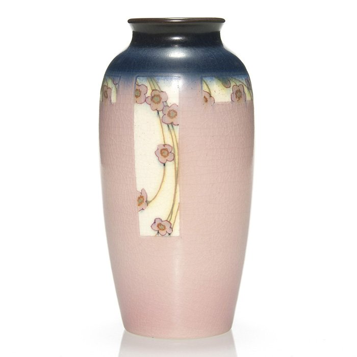 Rookwood vellum,floral McLaughlin, 1916, 7 3/4": Vellum Glaze vase encircled with white panels against a blue and pink ground, each panel being decorated with pink cherry blossoms by Charles McLaughlin in 1916. Marks include the Rookwood logo, date,
