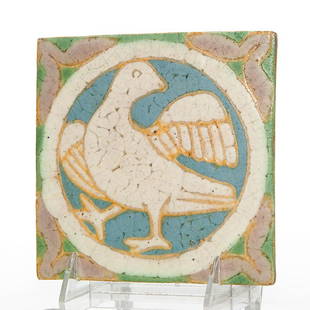 Grueby tile with bird, 6" x 6": Grueby tile decorated with a bird done in five different color mat glazes. The yellow glaze was applied to the bird using slip trailing and really adds definition, especially to the feathers. Impresse