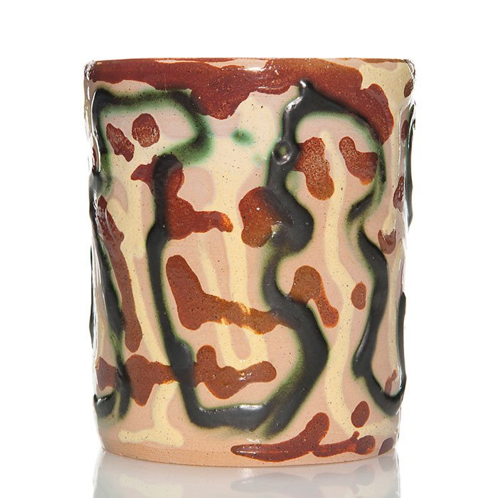 UND tumbler, Mattson, abstract designs, 4 1/8": UND 4 1/8 inch tumbler decorated with an abstract design in heavy brown, green and ivory slip against the pink clay body done by Julia Mattson. Incised on the bottom with the artist's monogram. This m