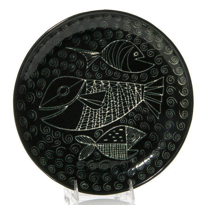 Aaron Bohrod charger, fish, Century House, 1 3/4": Aaron Bohrod for Century House, a pottery charger incised with a trio of smiling fish among coiled designs and covered in a jet black high glaze. Diameter is 11 3/4 inches. Incised Century House, Aaro
