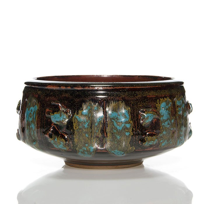 Vivika & Otto Heino bowl, 4 1/4" x 9": Vivika & Otto Heino bowl with incised and modeled decoration and covered with a coppery brown crystalline glaze with light blue and yellow highlights. Incised Vivika + Otto on the bottom. Size is 4 1/