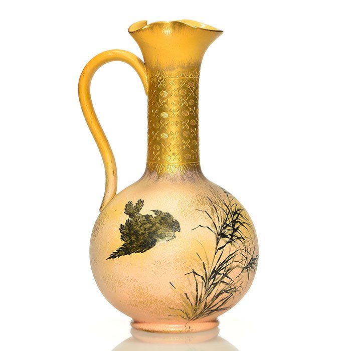 Rookwood Dull Finish ewer,Bookprinter, 1886, 8 3/8": Dull Finish ewer decorated with a bird flying amidst dark foliage, highlighted with gold accents, the work of Anna Bookprinter in 1886. The neck and rim are also accented with fired on gold. Marks inc