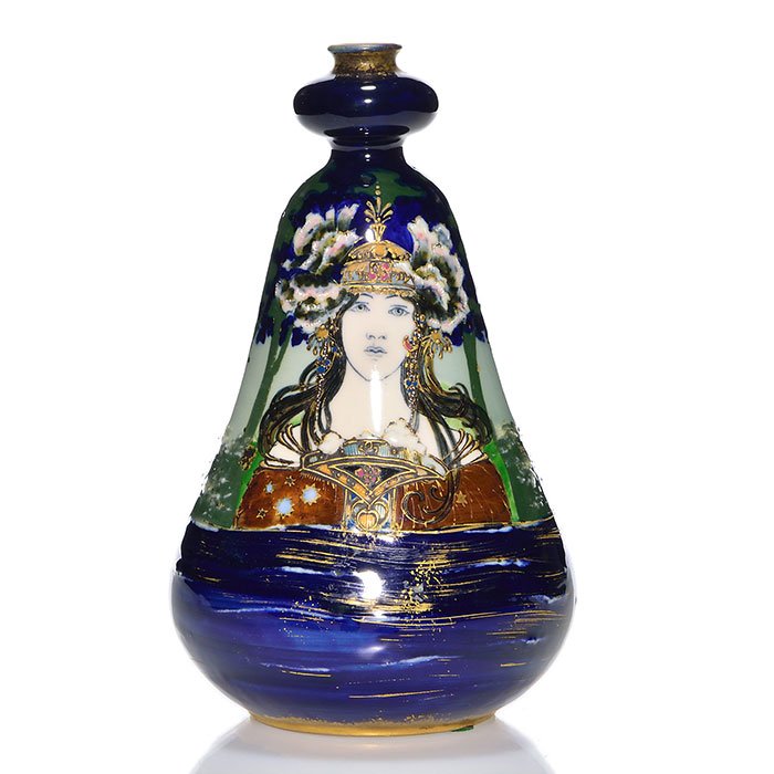 Amphora (R.St.&K.) vase, 8 3/8" woman in forest.: Reissner, Stellmacher & Kessel Ampora vase showing a young woman in very Germanic Dress with flowers in her headdress, standing in a forest. Done with slip trailing and painted in places with heavy sl