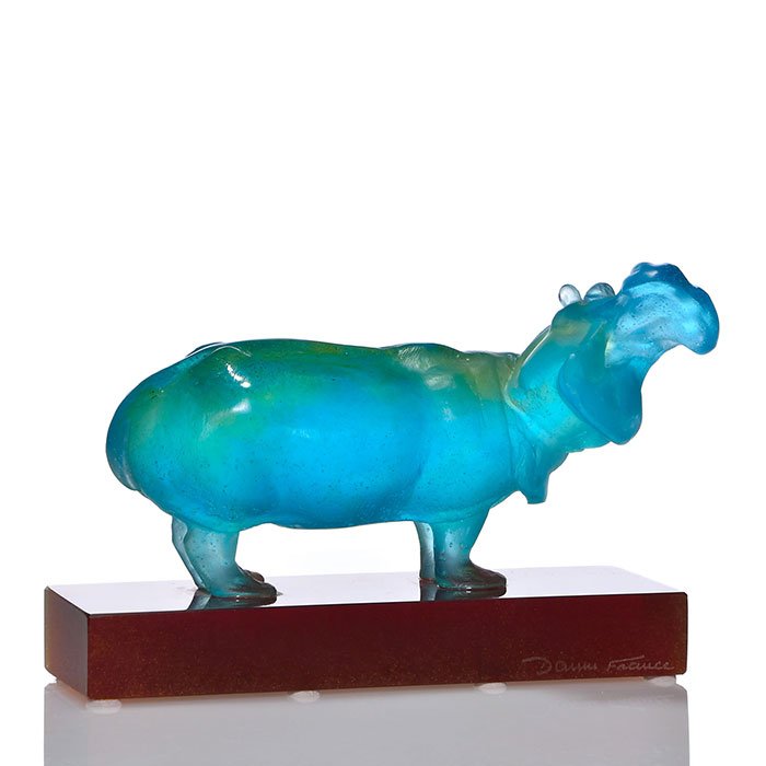 Modern Daum Pate-de-Verre Hippo, blue, 5"X7 1/4": Modern Daum pate-de-verre "Laughing Hippo" figure in turquoise blue mounted upon a dark honey amber base. Combined measurement is 5 inches by 7 1/4 inches long. Engraved "Daum France" on side of the b