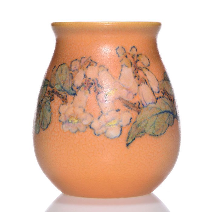 Rookwood mat vase, Pullman, 1928, 63, 4 1/4": Mat glaze vase encircled with trumpet flowers against a mottled orange ground, the work of John Wesley Pullman in 1928. Marks include the Rookwood logo, date, shape 63 and Mr. Pullman's monogram in bl