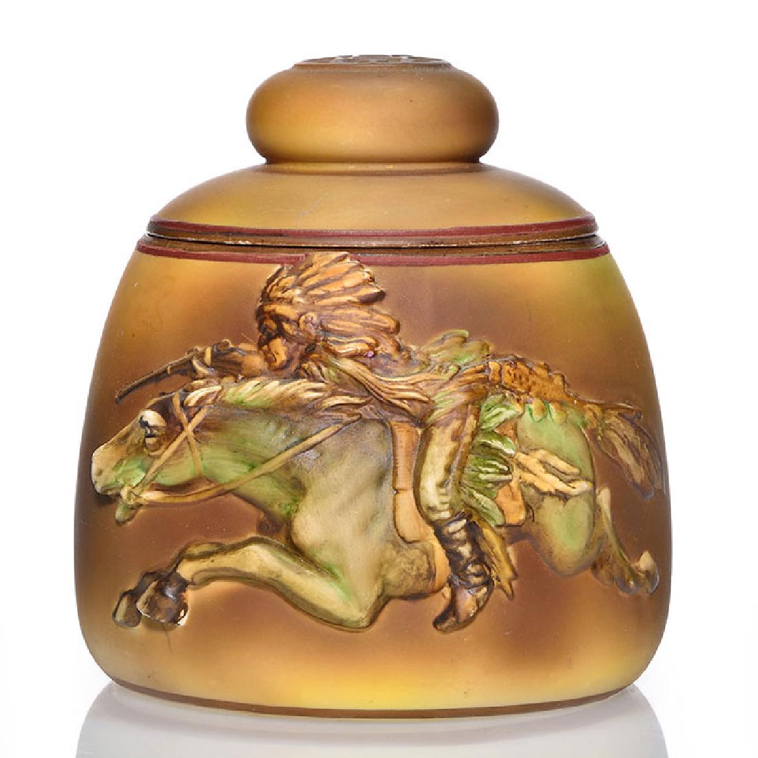 Nippon Indian on Horseback humidor, 6 1/4 inches: Nippon blown out humidor with the image of an Indian on horseback with a rifle, done in molded relief and then hand painted. Marked on the bottom with the green Nippon Hand Painted wreath logo. Height