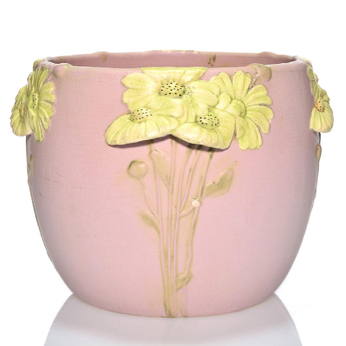 Weller pink jardiniere with applied yellow flowers, 7: Rare Weller pink mat glaze jardiniere with applied yellow flowers. Unmarked. There is fine overall crazing and there are some tiny nicks to the raised areas. Height 7 inches. The flowers are clearly a