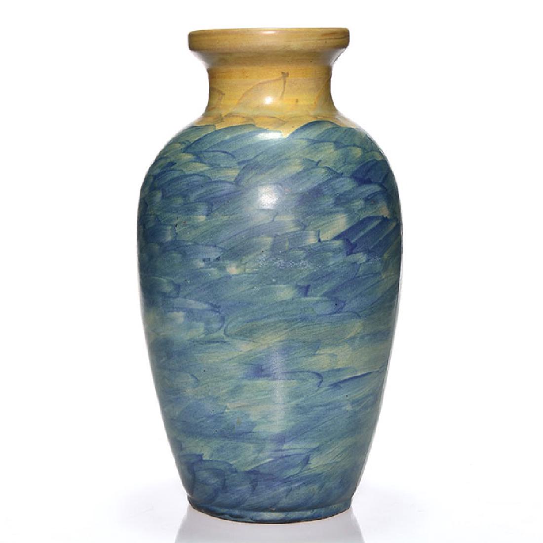 Peters and Reed Landsun lamp vase, 13 inches: Rare Peters and Reed Landsun lamp vase decorated in blue and tan and having a cast wiring hole in the side. Unmarked. There is a tiny nick at the edge of the cast wiring hole. Height is 13 inches.