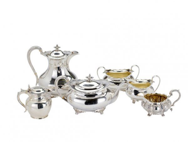 A SILVER FOUR-PIECE TEA SET, ATKIN BROTHERS (SILVER: A SILVER FOUR-PIECE TEA SET, ATKIN BROTHERS (SILVERSMITHS) LTD., SHEFFIELD, 1941 the bulbous bodies with moulded rims, on scroll and bun feet, teapot and hot water jug with urn finials and ivory insul