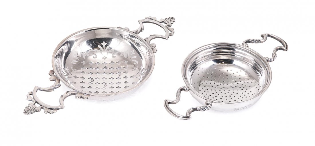A GEORGE II SILVER LEMON STRAINER, MAKER'S MARK PA: A GEORGE II SILVER LEMON STRAINER, MAKER'S MARK PARTLY OBLITERATED BY PIERCING, PROBABLY BENJAMIN WEST, LONDON, 1749 typical twin-handled form, 18.5cm wide; together with a Georgian style silver lemon