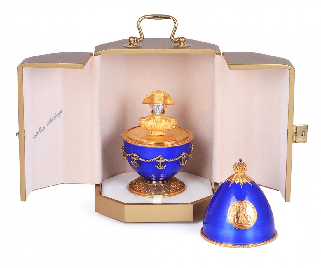 A PARCEL-GILT-SILVER AND ENAMEL TRAFALGAR EGG, THE: A PARCEL-GILT-SILVER AND ENAMEL TRAFALGAR EGG, THEO FABERGE, BIRMINGHAM, 2005 the cobalt blue guilloché enamel ground applied to the front with a relief of the battle after Auguste Mayer and to the r