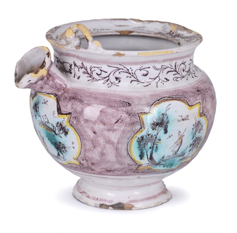 AN ITALIAN FAIENCE SPOUTED POT, MILAN OR PAVIA, CIRCA 1: AN ITALIAN FAIENCE SPOUTED POT, MILAN OR PAVIA, CIRCA 1760 elegantly painted in manganese and touches of green and yellow with figures in landscape vignettes against a sponged manganese ground, 21cm h