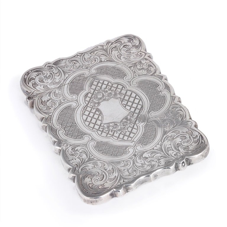 A VICTORIAN SILVER CARD CASE, HILLIARD & THOMASON,: A VICTORIAN SILVER CARD CASE, HILLIARD & THOMASON, BIRMINGHAM, 1859 shaped rectangular, profusely engraved with foliage, flowers and diaper decoration within scroll reserves 9.6cm high