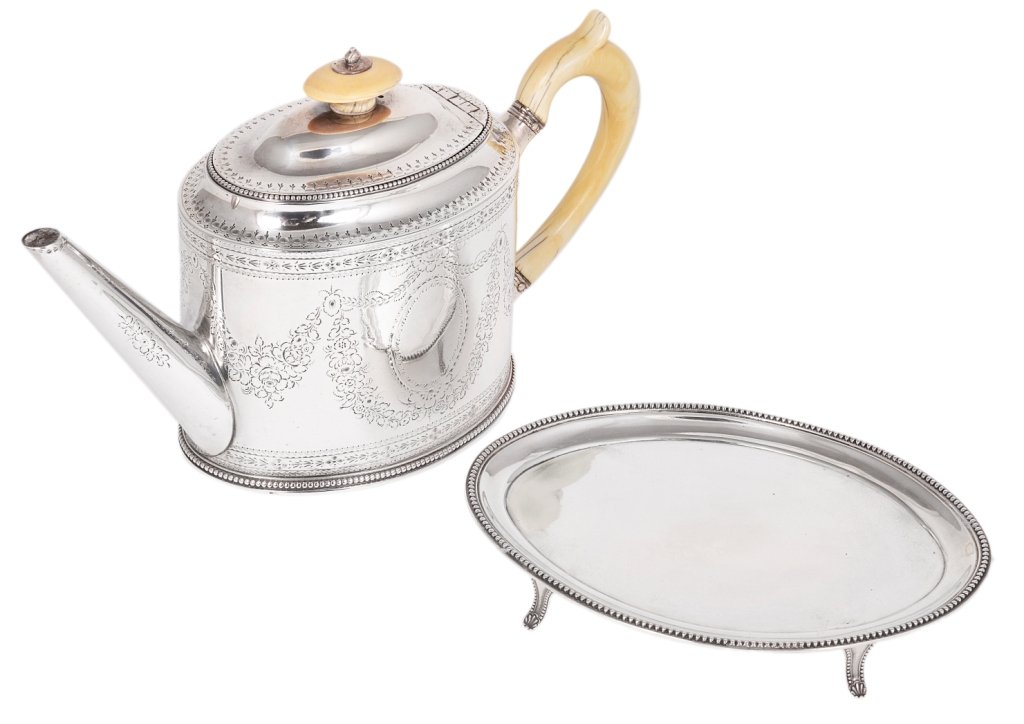 A GEORGE III SILVER TEAPOT, HESTER BATEMAN, LONDON,: A GEORGE III SILVER TEAPOT, HESTER BATEMAN, LONDON, 1783, ON AN ASSOCIATED STAND, THOMAS OLIPHANT OF MANCHESTER OVERSTRIKING ANOTHER, LONDON, 1791 oval with beaded rims, the teapot with bright-cut vac