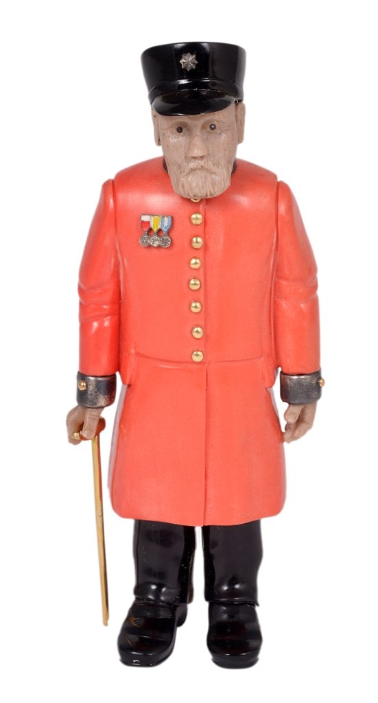 A RUSSIAN STYLE CARVED HARDSTONE FIGURE OF A CHELSEA: A RUSSIAN STYLE CARVED HARDSTONE FIGURE OF A CHELSEA PENSIONER, AFTER KARL FABERGE, 20TH CENTURY with cachalong face, obsidian boots and hat, gold cane and buttons and silver cuffs and collar 10.8cm h