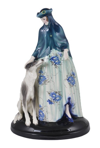 A GOLDSCHEIDER POTTERY FIGURE OF A VENETIAN LADY,: A GOLDSCHEIDER POTTERY FIGURE OF A VENETIAN LADY, DESIGNED BY JOSEPH LORENZL (1893-1950), VIENNA, CIRCA 1931 model number 6557, in blue cape and hat caressing the borzoi by her side, black oval base, 