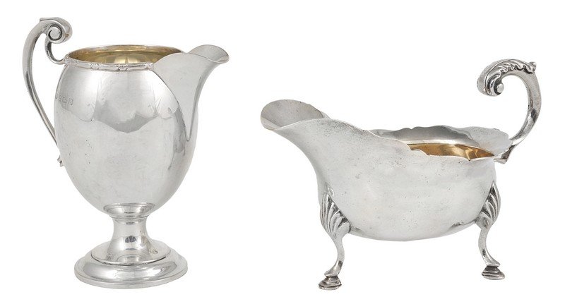 A VICTORIAN SILVER SAUCEBOAT, CHARLES STUART HARRIS,: A VICTORIAN SILVER SAUCEBOAT, CHARLES STUART HARRIS, LONDON, 1897 oval, with C-scroll handle and on three shell-headed pad feet, 14.5cm long; together with a George V silver cream jug, F.C. Richards,