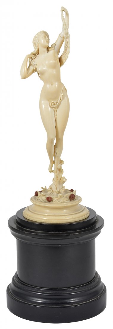 A FRENCH IVORY FIGURE OF VENUS, DIEPPE, LATE 19TH: A FRENCH IVORY FIGURE OF VENUS, DIEPPE, LATE 19TH CENTURY carved as the birth of the goddess, the nude figure holding up her tresses in one hand, a delicate tendril of seaweed encircling her torso as 