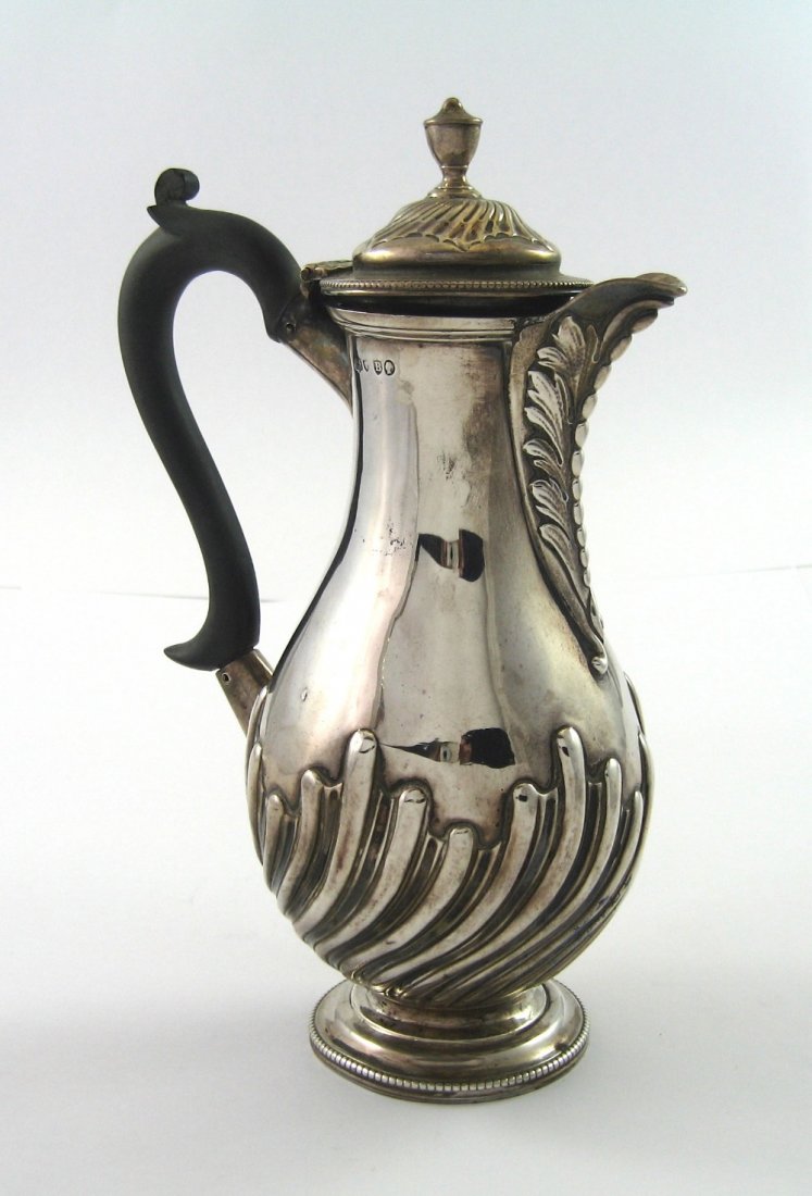 A VICTORIAN SILVER HOT WATER JUG, CHARLES STUART: A VICTORIAN SILVER HOT WATER JUG, CHARLES STUART HARRIS, LONDON, 1877 baluster, with chased bands of alternate lobes and flutes and acanthus and bead cast spout 22cm high, 409gr (13oz) including compo