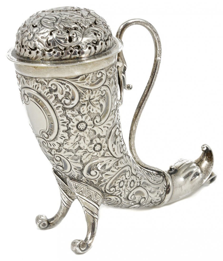 A VICTORIAN SILVER NOVELTY PEPPERETTE, HENRY MATTHEWS,: A VICTORIAN SILVER NOVELTY PEPPERETTE, HENRY MATTHEWS, BIRMINGHAM, 1899 in the form of a drinking horn with grotesque mask terminal, volute feet and scroll handle, covered in scroll foliage surroundin