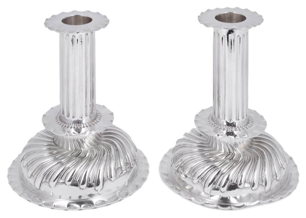 A PAIR OF VICTORIAN SILVER DESK CANDLESTICKS, CHARLES: A PAIR OF VICTORIAN SILVER DESK CANDLESTICKS, CHARLES STUART HARRIS, LONDON, 1886/87 in Charles II taste, the wood filled domed bases with a band of curved alternate lobes and flutes below small platf