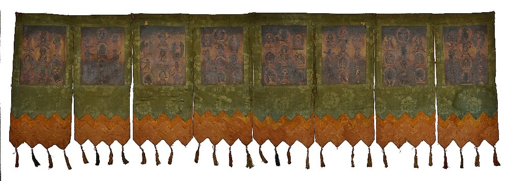 A TEMPLE HANGING, TIBET 19TH CENTURY composed of a row: A TEMPLE HANGING, TIBET 19TH CENTURY composed of a row of eight tsaklis, each depicting various Buddhist figures, including Buddhas, bodhisattvas, dakinis and lamas, mounted on Chinese silk brocade pa