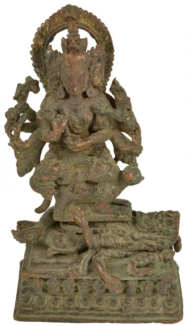 A BRONZE FIGURE OF A TANTRIC GODDESS(?), NEPAL, CIRCA: A BRONZE FIGURE OF A TANTRIC GODDESS(?), NEPAL, CIRCA 16TH CENTURY the multi-armed, multi-headed deity seated on a rat, resting on the prostrate corpse of a male deity, holding various attributes incl
