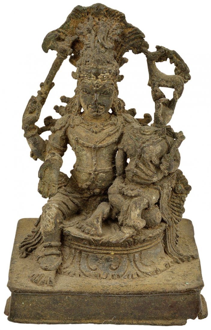 A BRONZE FIGURE OF SIVA AND PARVATI, KERALA, SOUTH: A BRONZE FIGURE OF SIVA AND PARVATI, KERALA, SOUTH INDIA, 16TH CENTURY seated on a lotus throne on rectangular base, the four-armed god with long flaring hair, holding his consort on his left knee, ho