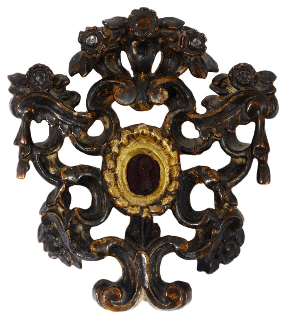 AN ITALIAN CARVED GILTWOOD RELIQUARY FRAME, 18TH: AN ITALIAN CARVED GILTWOOD RELIQUARY FRAME, 18TH CENTURY with openwork scrolls and flowerheads, the oval aperture set with a red glass intaglio profile, English School, late 18th century of a young ma